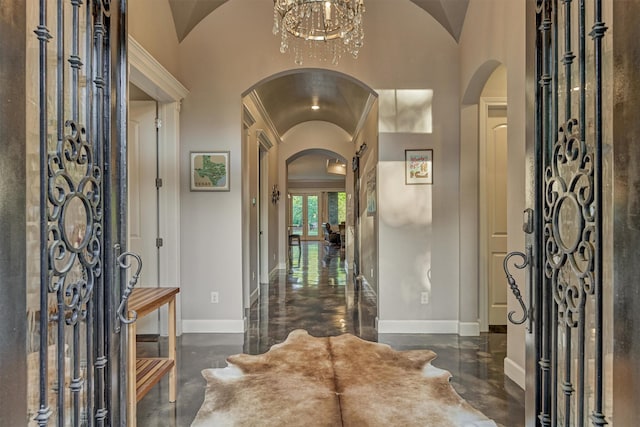 12122 Hawthorne Dr, Montgomery, TX 77356 - entrance foyer with arched walkways, finished concrete floors, vaulted ceiling, and a chandelier