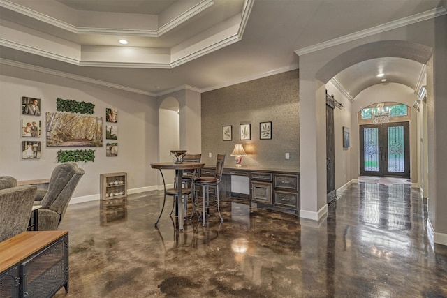 12122 Hawthorne Dr, Montgomery, TX 77356 - dining area with arched walkways, concrete flooring, a raised ceiling, a chandelier, and ornamental molding