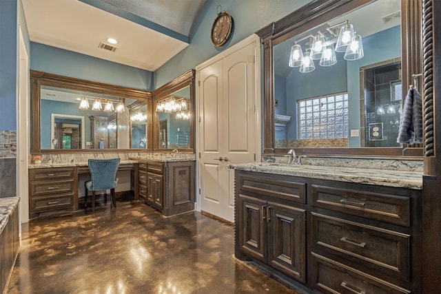 12122 Hawthorne Dr, Montgomery, TX 77356 - bathroom with a chandelier, finished concrete flooring, two vanities, and vaulted ceiling