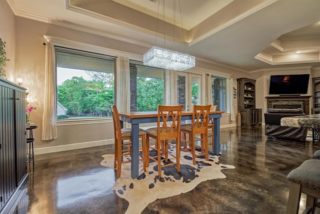 12122 Hawthorne Dr, Montgomery, TX 77356 - dining room with a tray ceiling, crown molding, finished concrete flooring, and a chandelier