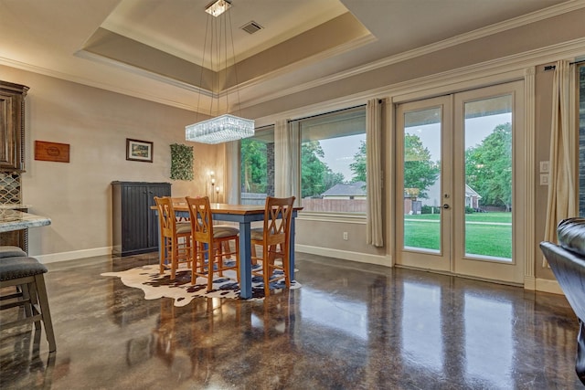 12122 Hawthorne Dr, Montgomery, TX 77356 - dining room with french doors, concrete floors, a raised ceiling, and ornamental molding