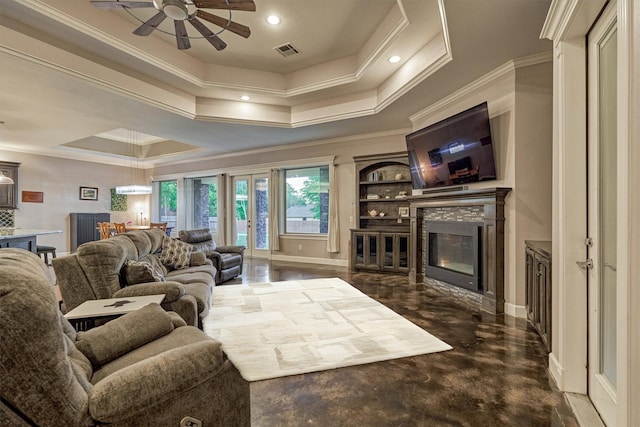 12122 Hawthorne Dr, Montgomery, TX 77356 - living area featuring a ceiling fan, a glass covered fireplace, ornamental molding, a raised ceiling, and recessed lighting