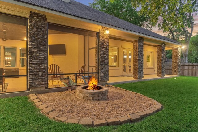 12122 Hawthorne Dr, Montgomery, TX 77356 - back of property featuring stone siding, a fire pit, french doors, and a patio