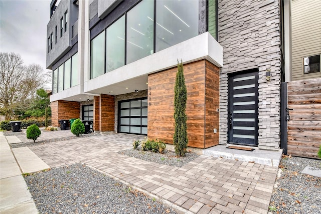 entrance to property featuring driveway and a garage