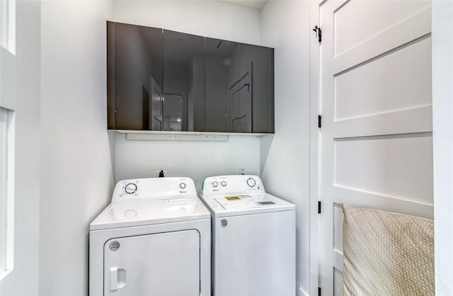 laundry area with cabinet space and washing machine and dryer