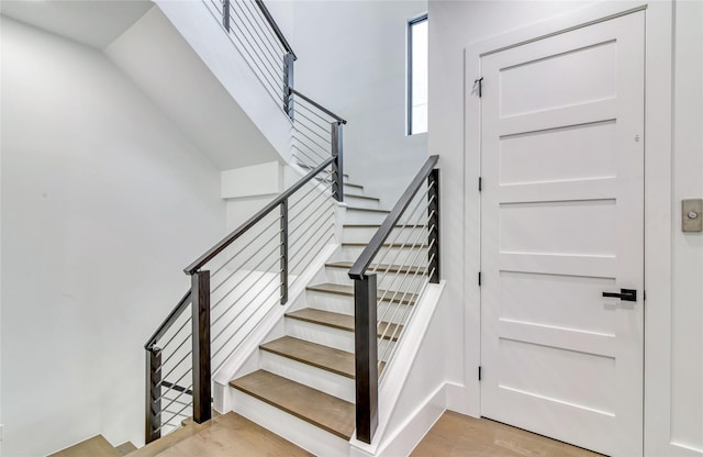stairway with wood finished floors