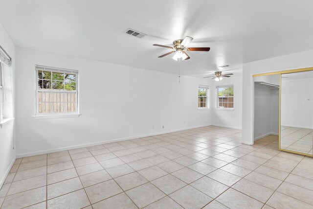 1035 Forestburg Dr, Houston, TX 77038 - unfurnished bedroom featuring light tile patterned flooring, a ceiling fan, a closet, and baseboards