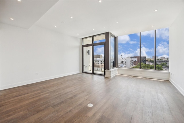 2323 W Main St Unit 603, Houston, TX 77098 - empty room with wood finished floors, baseboards, recessed lighting, and a city view