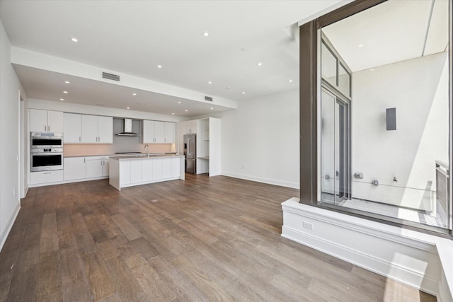 2323 W Main St Unit 603, Houston, TX 77098 - unfurnished living room with dark wood-style floors, baseboards, recessed lighting, and a sink