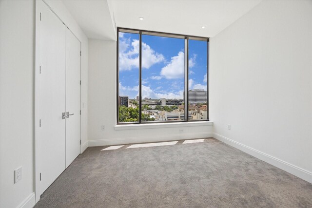 2323 W Main St Unit 603, Houston, TX 77098 - unfurnished bedroom featuring carpet flooring, baseboards, and a city view