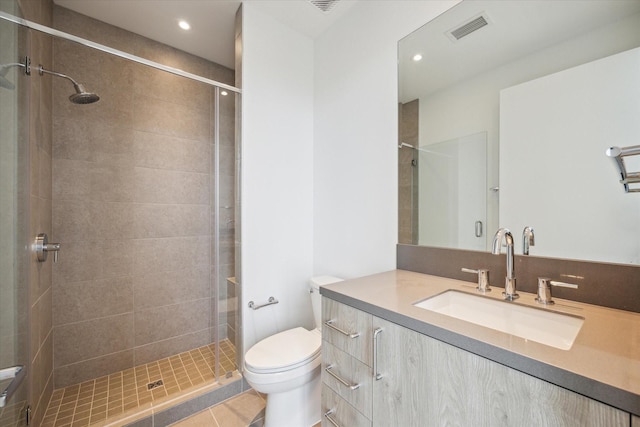 2323 W Main St Unit 603, Houston, TX 77098 - bathroom featuring a shower stall, toilet, vanity, recessed lighting, and tile patterned floors