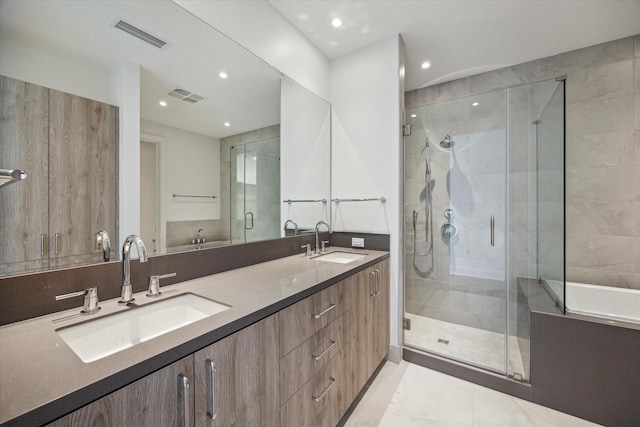 2323 W Main St Unit 603, Houston, TX 77098 - full bath featuring a stall shower, double vanity, recessed lighting, and tile patterned floors