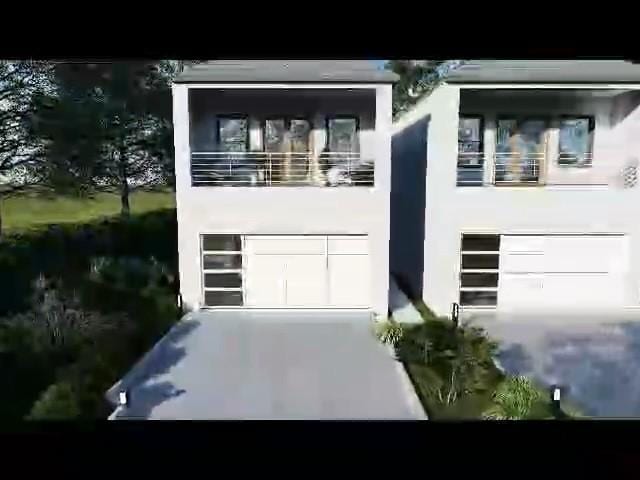 view of front of house featuring an attached garage and stucco siding