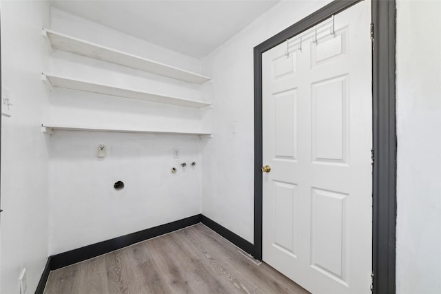 laundry room with laundry area, hookup for a washing machine, wood finished floors, hookup for an electric dryer, and baseboards