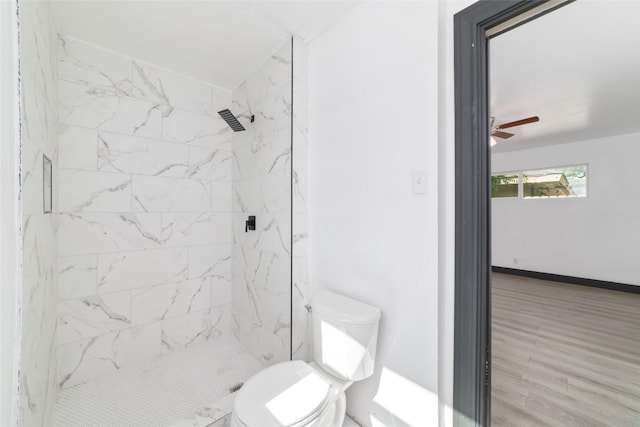 full bath with a marble finish shower, a ceiling fan, and toilet
