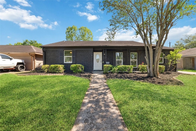 ranch-style home with brick siding, an attached garage, and a front lawn