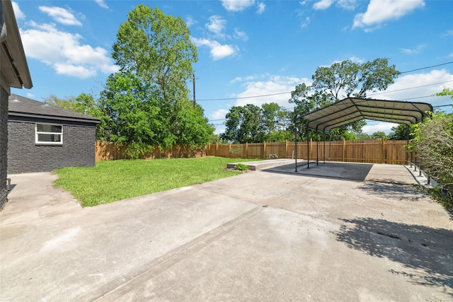 view of patio featuring a detached carport, fence private yard, and concrete driveway