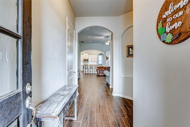 29114 Autumn Brook Dr, Fulshear, TX 77441 - entryway with arched walkways, a ceiling fan, visible vents, dark wood-style flooring, and baseboards