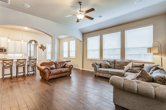 29114 Autumn Brook Dr, Fulshear, TX 77441 - living area featuring visible vents, ceiling fan, arched walkways, and dark wood finished floors
