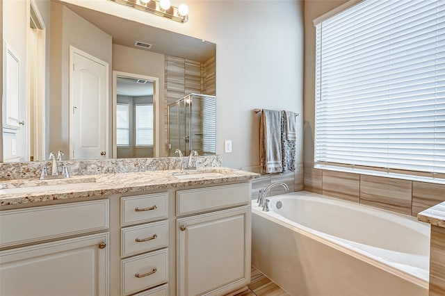 29114 Autumn Brook Dr, Fulshear, TX 77441 - bathroom with visible vents, a sink, double vanity, a stall shower, and a garden tub