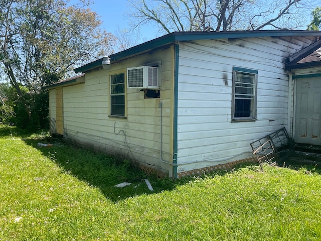 7413 W Knoll St, Houston, TX 77028 - view of side of property featuring an AC wall unit and a yard