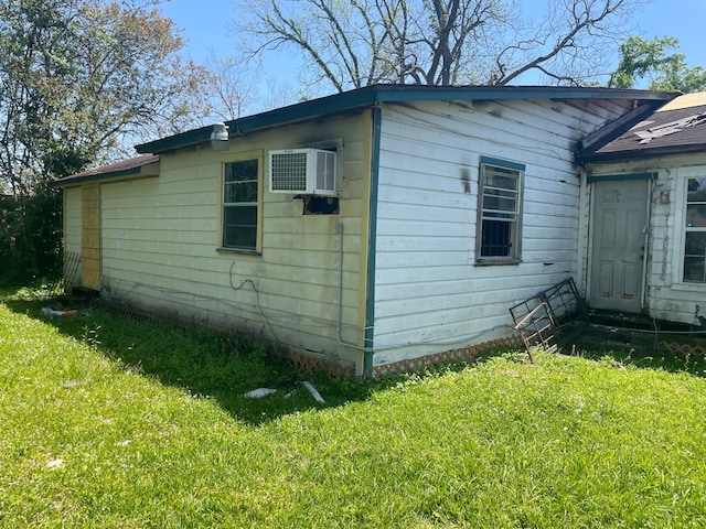 7413 W Knoll St, Houston, TX 77028 - view of side of property with a yard and a wall unit AC