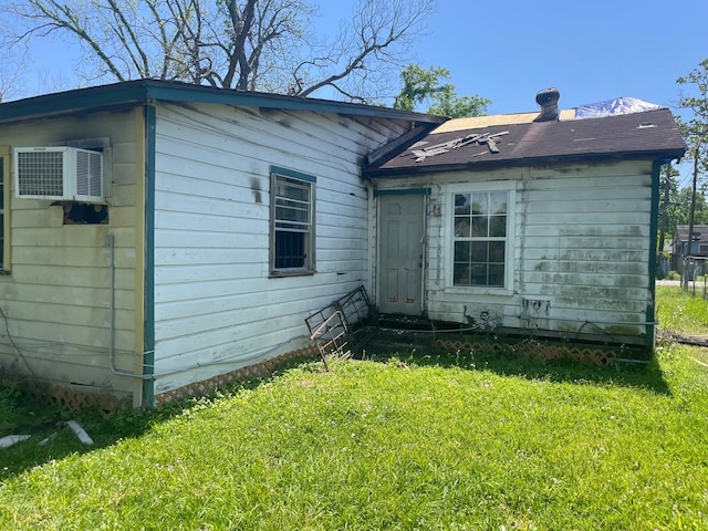 7413 W Knoll St, Houston, TX 77028 - exterior space with a wall unit AC and a lawn