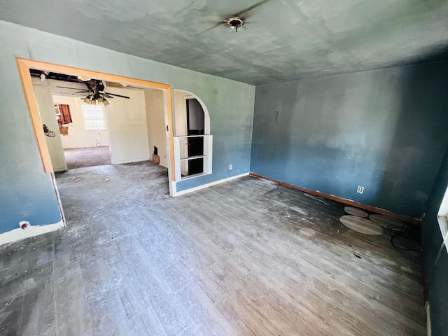 7413 W Knoll St, Houston, TX 77028 - spare room featuring wood finished floors, arched walkways, and baseboards
