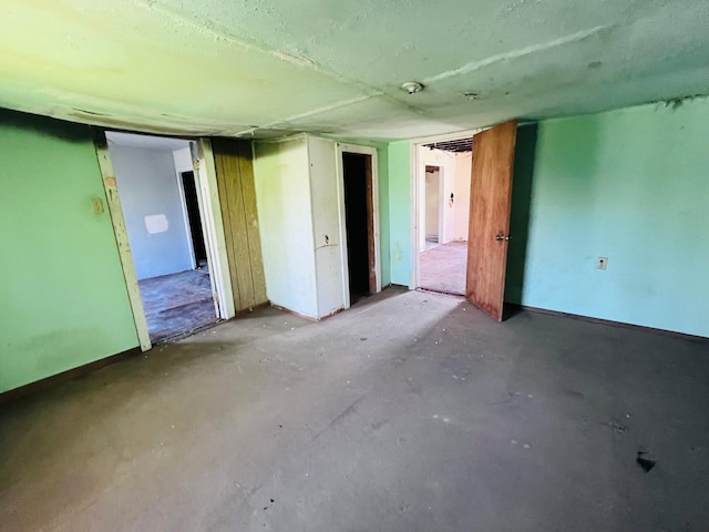 7413 W Knoll St, Houston, TX 77028 - spare room featuring concrete flooring and baseboards