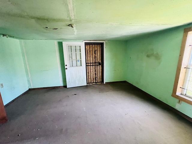 7413 W Knoll St, Houston, TX 77028 - empty room featuring concrete floors and baseboards