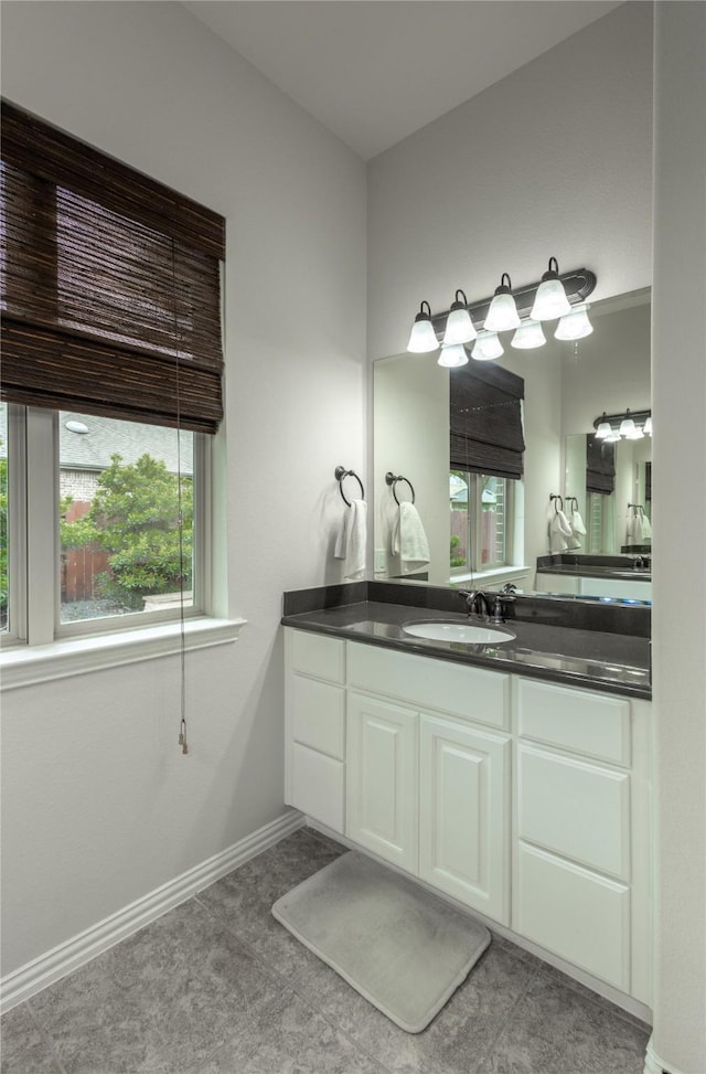 bathroom with vanity and baseboards