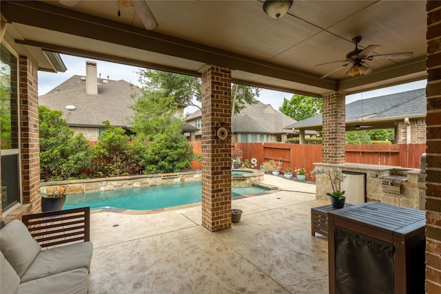 view of swimming pool featuring a patio, a pool with connected hot tub, and a fenced backyard