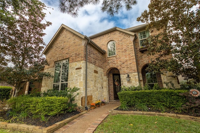 view of front of house with stone siding and brick siding
