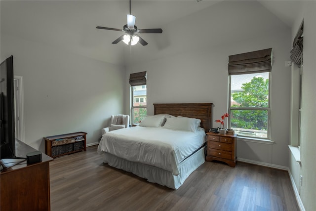 bedroom featuring wood finished floors, ceiling fan, baseboards, and lofted ceiling