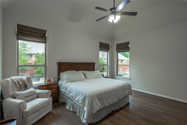 bedroom with baseboards, multiple windows, ceiling fan, and dark wood-style floors