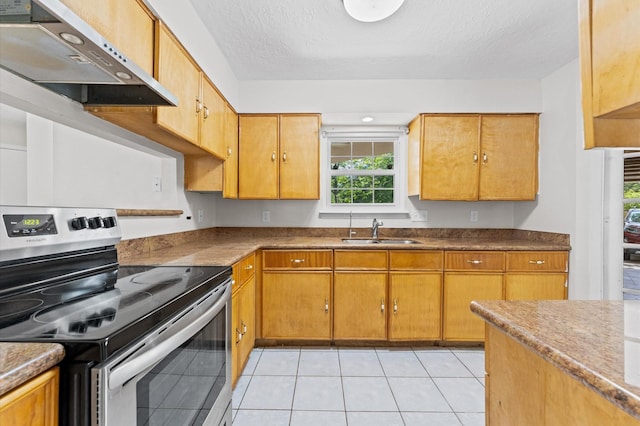 kitchen featuring light tile patterned floors, stainless steel range with electric stovetop, under cabinet range hood, and a sink