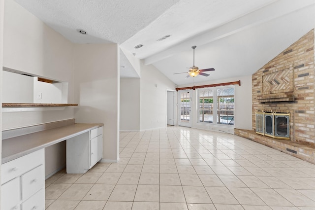 unfurnished living room with beamed ceiling, ceiling fan, visible vents, a fireplace, and high vaulted ceiling