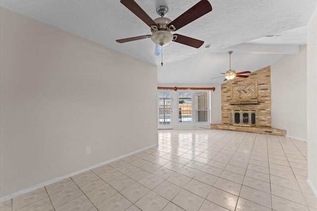unfurnished living room featuring light tile patterned flooring, a textured ceiling, ceiling fan, and baseboards