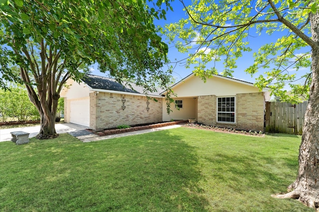 back of house with a lawn, fence, a garage, and brick siding
