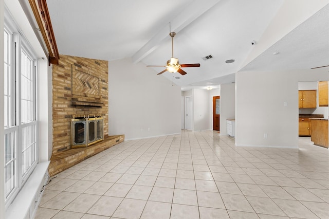 unfurnished living room with lofted ceiling with beams, ceiling fan, a brick fireplace, baseboards, and light tile patterned flooring