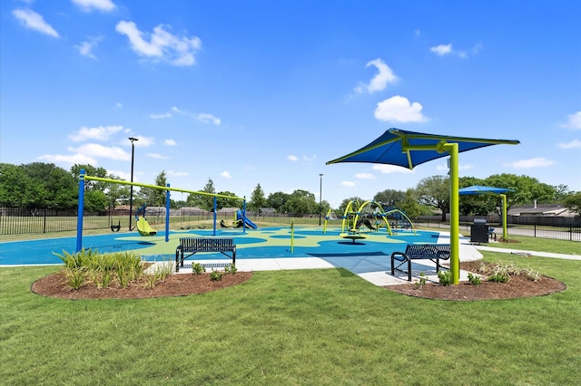 community playground featuring fence and a yard