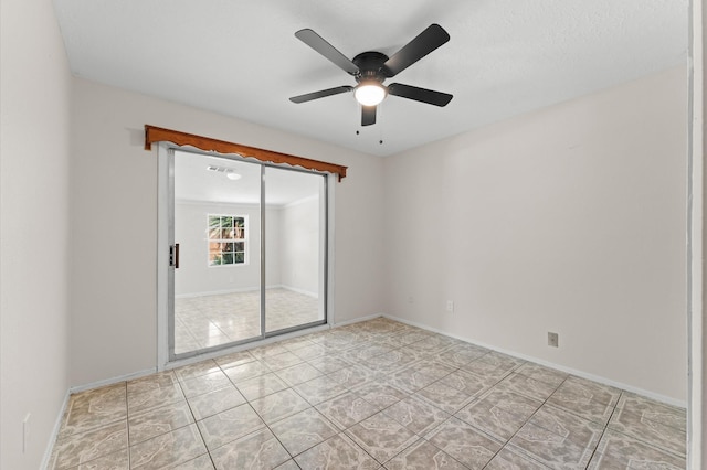 unfurnished room featuring baseboards, ceiling fan, and light tile patterned flooring