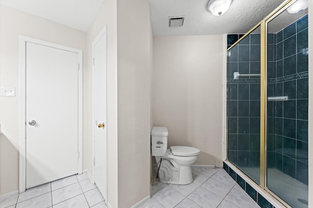 full bathroom featuring toilet, a shower stall, and tile patterned floors