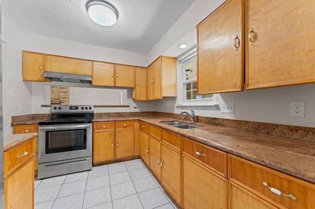 kitchen with range hood, a sink, light tile patterned floors, stainless steel range with electric cooktop, and a textured ceiling