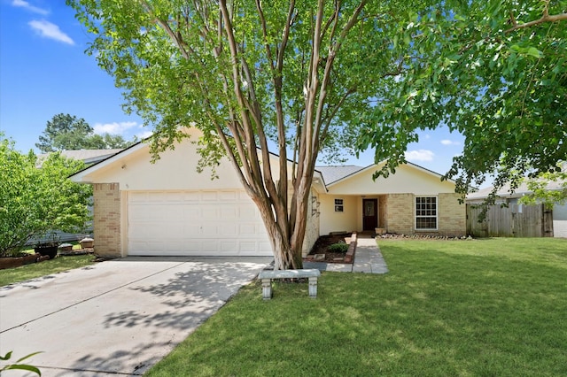 view of front of home featuring brick siding, fence, a front yard, and concrete driveway