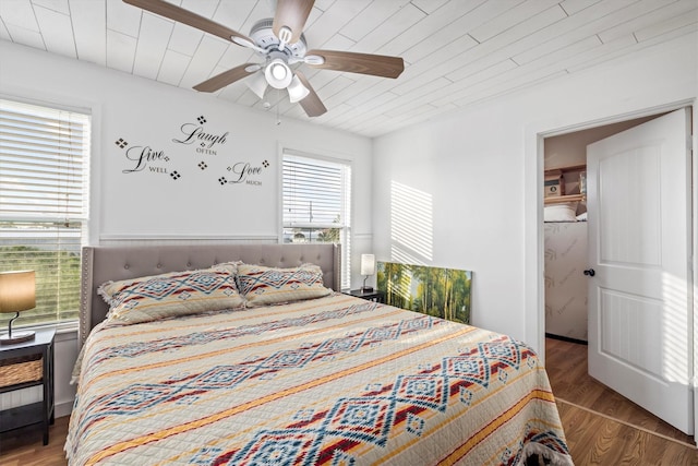 bedroom featuring wood finished floors, wood ceiling, and ceiling fan
