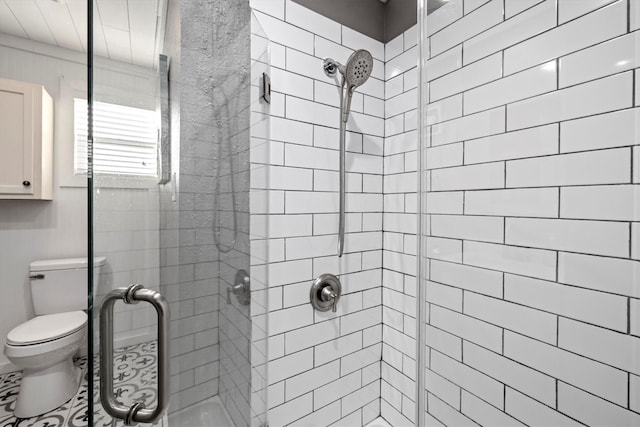 bathroom with a shower stall and toilet