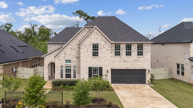 17583 Harpers Way, Conroe, TX 77385 - french provincial home with fence, a front lawn, brick siding, and a garage