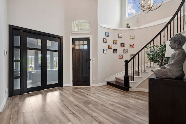 17583 Harpers Way, Conroe, TX 77385 - foyer entrance with baseboards, stairway, wood finished floors, and a notable chandelier