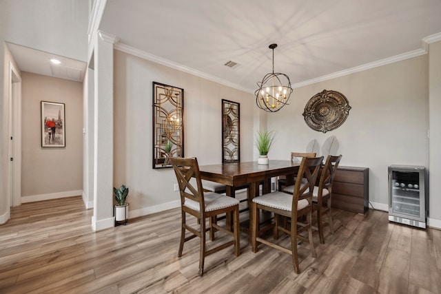 17583 Harpers Way, Conroe, TX 77385 - dining area with an inviting chandelier, beverage cooler, light wood-style flooring, and baseboards